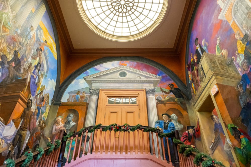 A photo of the entrance to the balcony in Old Cabell Hall, which is decorated by the mural "The Student's Progress" by Lincoln Perry.